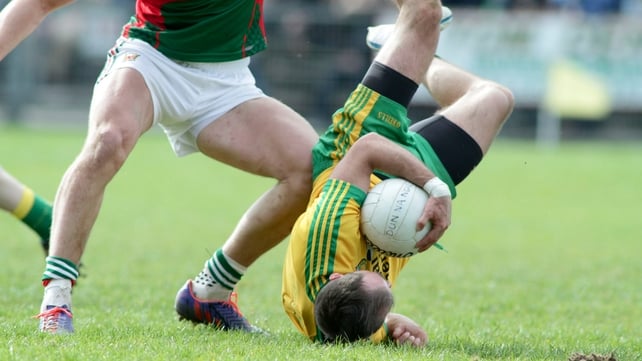 Donegal's Karl Lacey takes a tumble against Mayo