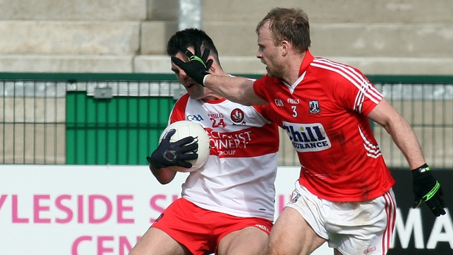 Derry's Eoin Bradley is put under pressure by Cork's Michael Shields in their Allianz Football League clash