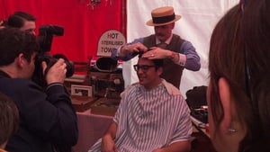 A man has his hair combed to replicate the style of the era