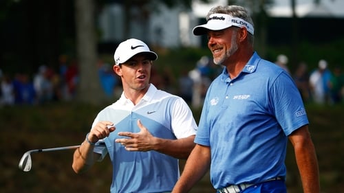 Rory McIlroy and Darren Clarke walk together during a practice round prior to the start of the PGA Championship at Valhalla Golf Club in 2014
