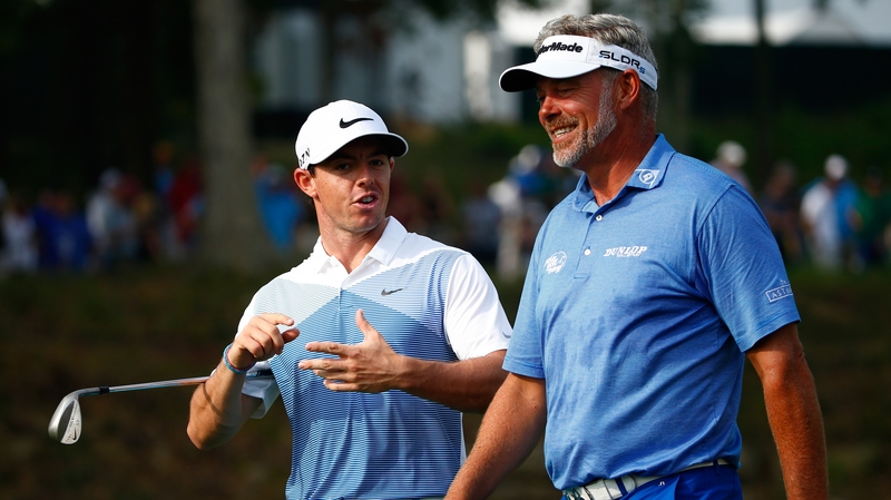 Rory McIlroy and Darren Clarke walk together during a practice round prior to the start of the PGA Championship at Valhalla Golf Club in 2014