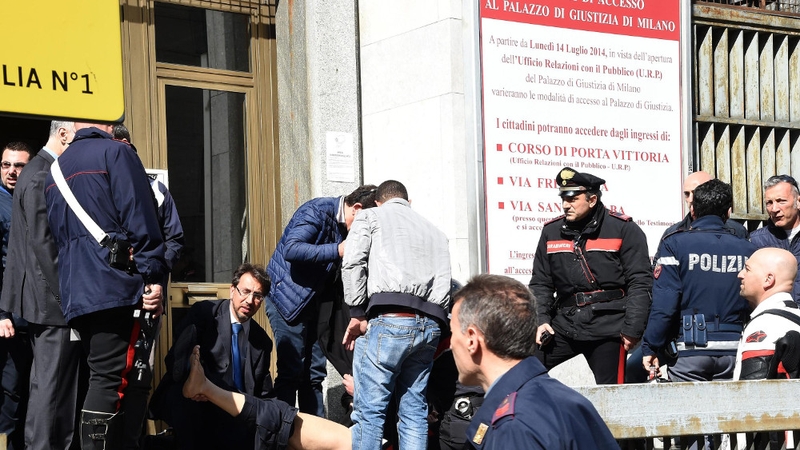 An injured man is treated following the shooting