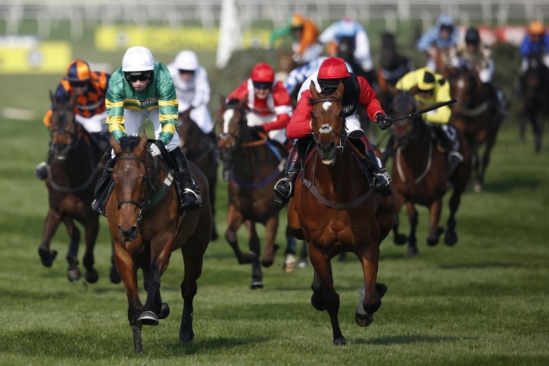 Nina Carberry riding On The Fringe (L) pulls away from Pacha Du Polder to win the Crabbie's Fox Hunters' Steeple Chase