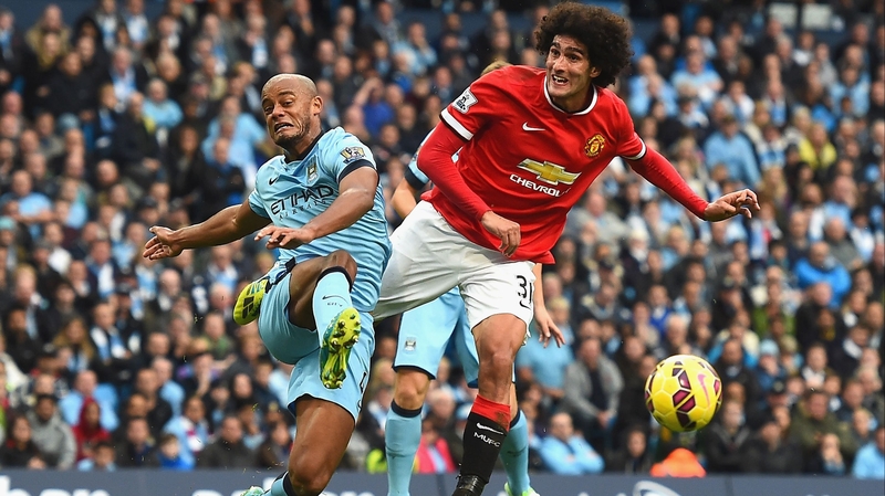 Vincent Kompany and Marouane Fellaini in action at Old Trafford in 2015