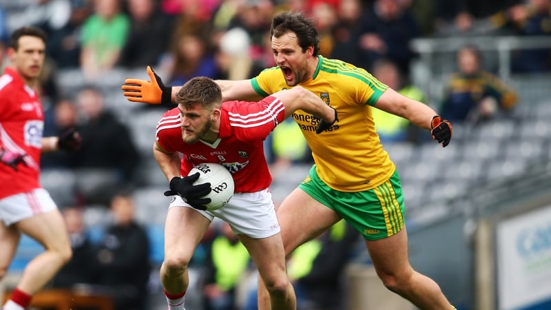 Cork's Eoin Cadogan under pressure from Michael Murphy of Donegal