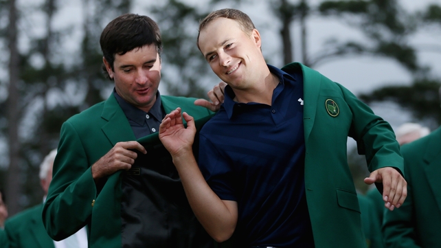 Bubba Watson adorns Jordan Spieth with the famous Green Jacket after the youngster won the 79th Masters by four shots