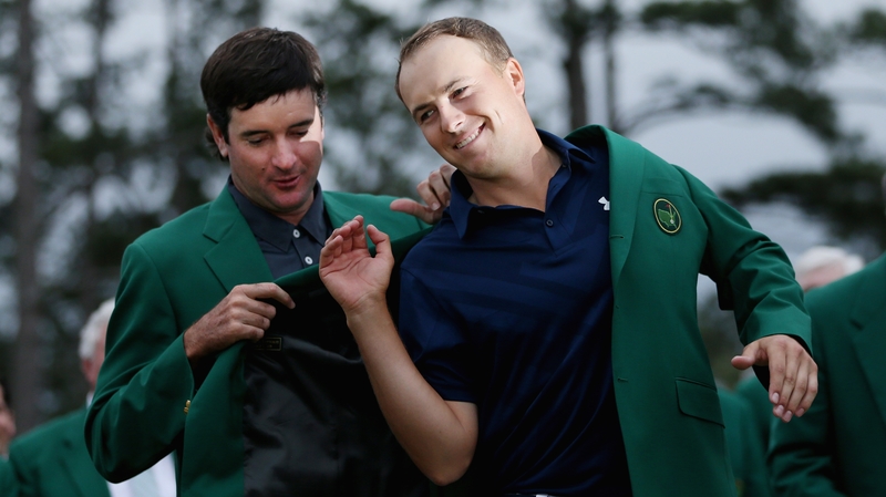 Last year's champion Bubba Watson presents Jordan Spieth with the green jacket