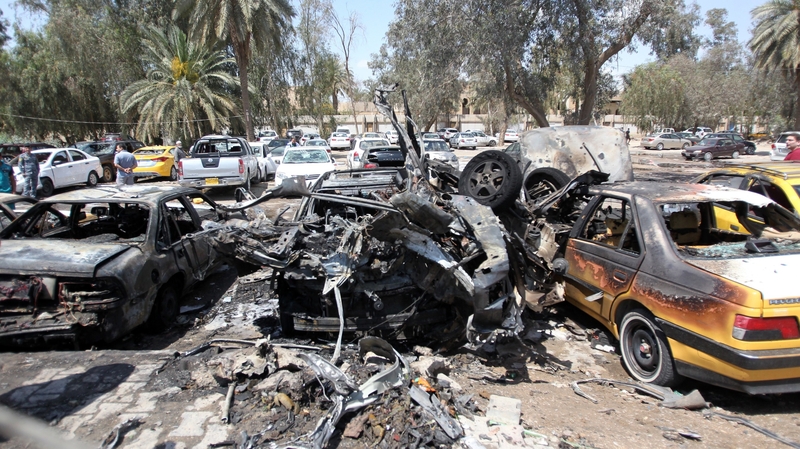 Burnt-out cars at the site of an explosion at the car park near Baghdad's al-Yarmuk hospital