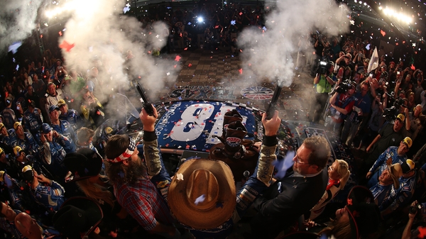 Jimmie Johnson, driver of the #48 Lowe's Pro Services Chevrolet, celebrates with commemorative pistols after winning the NASCAR Sprint Cup Series Duck Commander 500 at Texas Motor Speedway