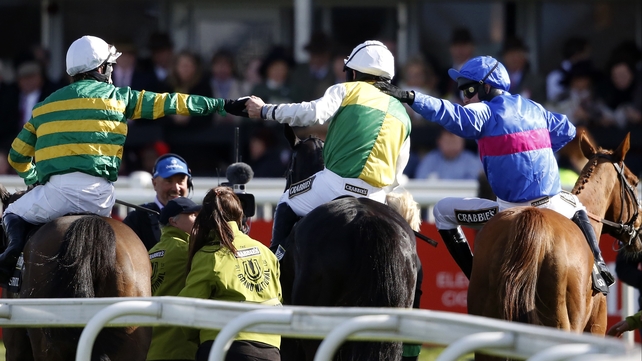 Leighton Aspell (C) is congratulated by Tony McCoy (L) and Paul Moloney (R) after winning the Grand National on Many Clouds at Aintree racecourse, Liverpool
