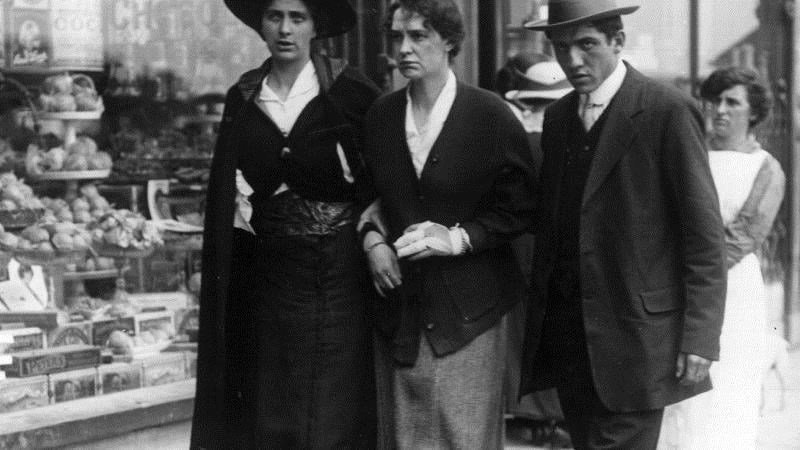 The visibly haunted faces of survivors of the Lusitania walking on a street in Cobh in 1915