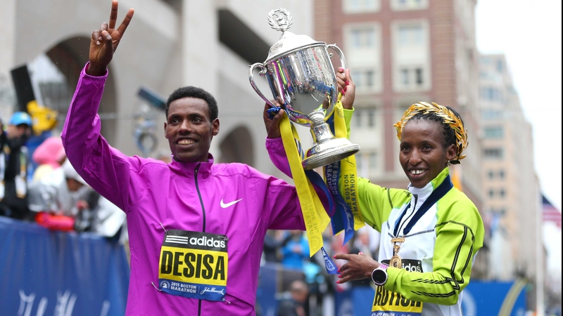Lelisa Desisa and Caroline Rotitch celebrate their successes at the 119th Boston Marathon