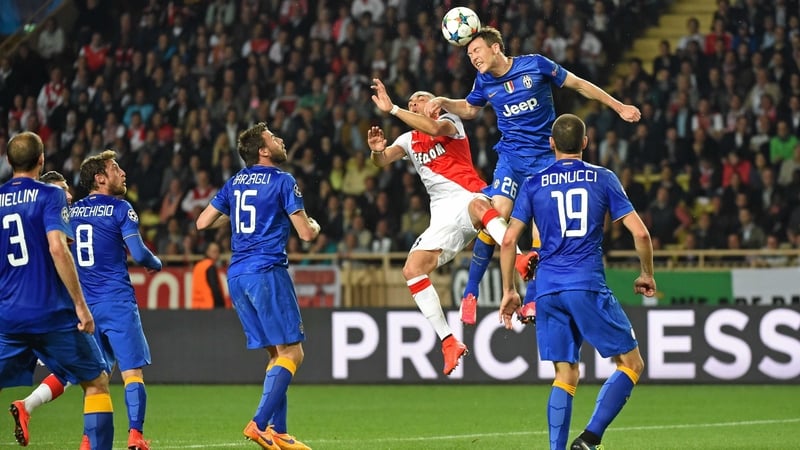 Juventus defender Stephan Lichtsteiner and Monaco's Layvin Kurzawa contest a cross