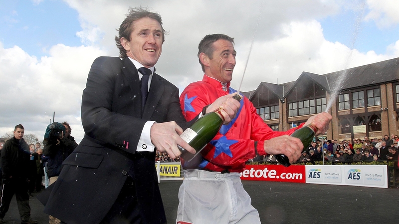 Tony McCoy (L) and Davy Russell celebrating their respective UK and Irish champion jockey titles in 2012