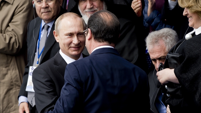 Russian President Vladimir Putin greets Francois Hollande at the centenary commemoration in Yerevan