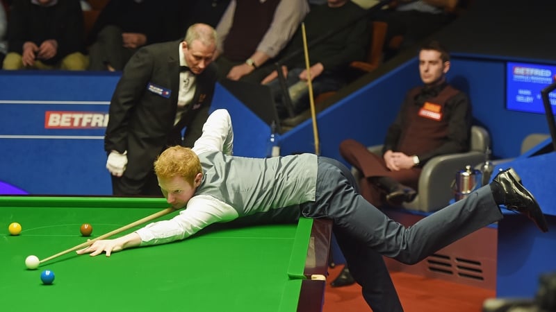 Mark Selby watches on as Anthony McGill builds another break