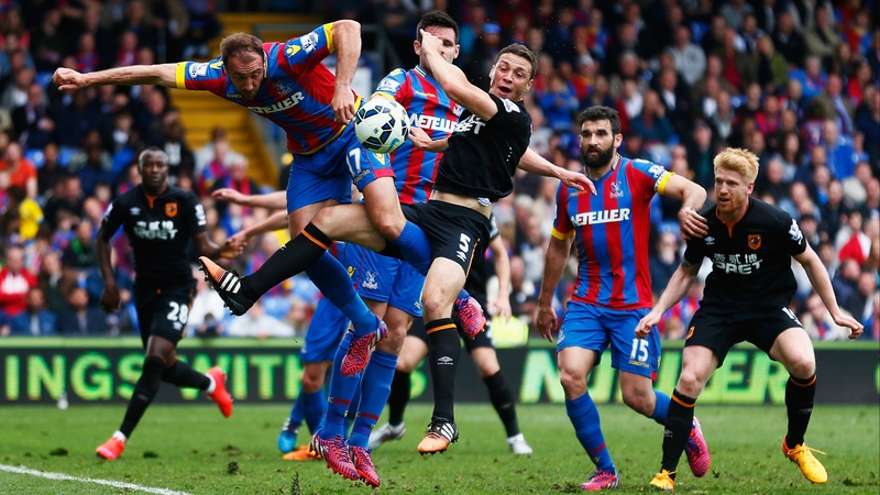 Andy Johnson of Crystal Palace tangles with Hull's James Chester at the front post