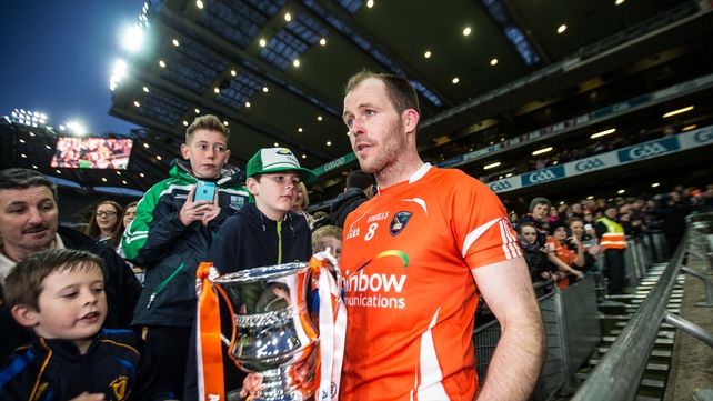 Armagh captain Ciaran McKeever walks past some young Fermanagh fans while holding his newly acquired Allianz Football League Division 3 trophy