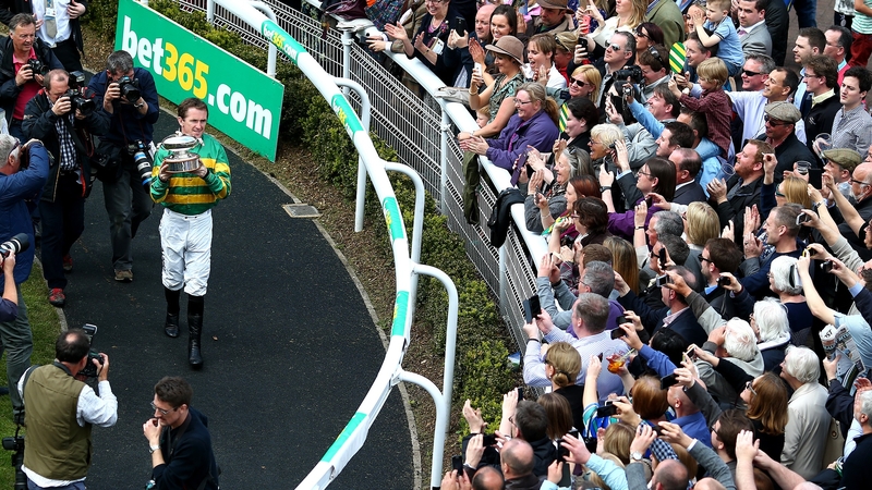Tony McCoy parades his 20th Champions Jockey Trophy at Sandown