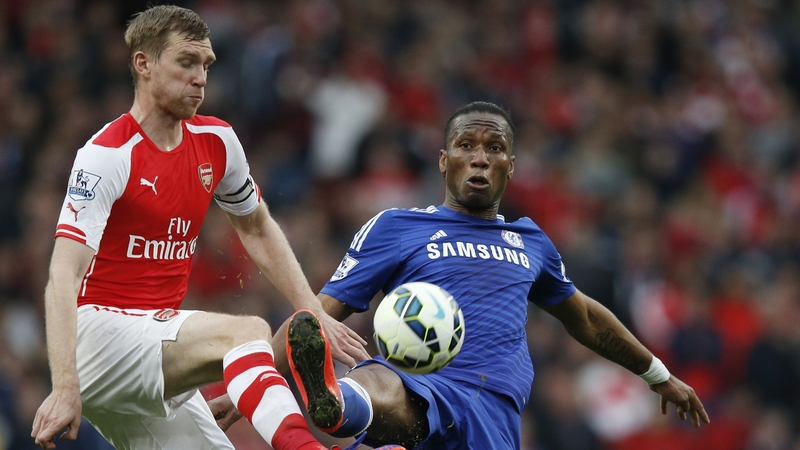 Chelsea's Didier Drogba (R) vies with Arsenal's Per Mertesacker during the game
