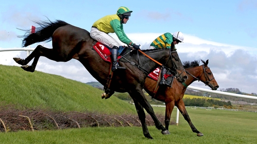 Wish Ye Didn't ridden by Nina Carberry (far side) lands on the way to winning the first race of the day