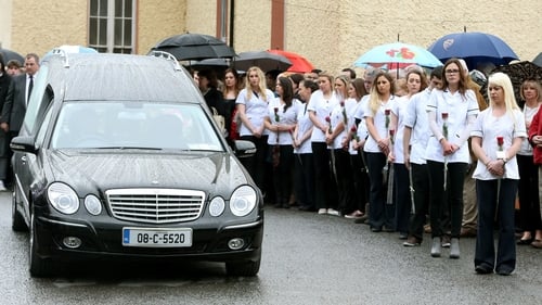 The hearse carrying Karen Buckley's coffin is flanked by nurses from her University of Limerick graduation year