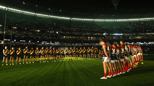 The Tigers and Demons stand for a minute's silence for Anzac Day during their round four AFL match at Melbourne Cricket Ground