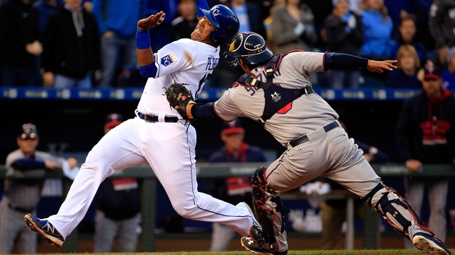 Salvador Perez of the Kansas City Royals is tagged out at home plate by catcher Kurt Suzuki of the Minnesota Twins while trying to score during the second inning of their clash at Kauffman Stadium