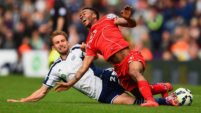 Craig Dawson of West Brom tackles Raheem Sterling of Liverpool during their Barclays Premier League clash