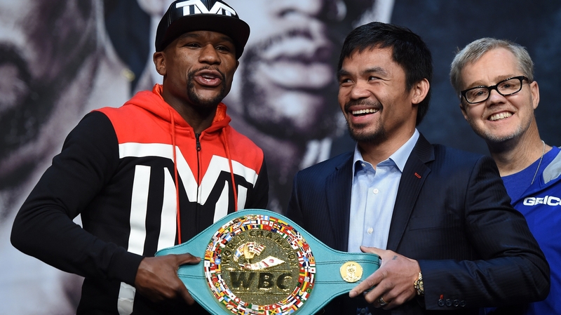 Manny Pacquiao's trainer Freddie Roach (R) alongside the fighter and Floyd Mayweather Jr (L) in Las Vegas yesterday