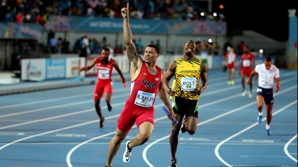 Ryan Bailey crosses the line ahead of Usain Bolt