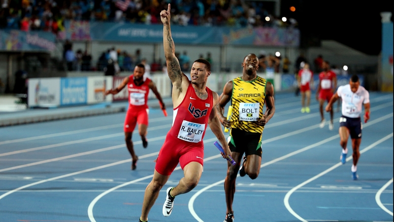 Ryan Bailey crosses the line ahead of Usain Bolt
