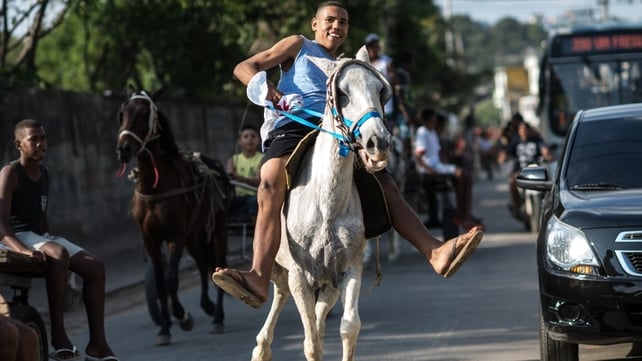 Residents of Rio de Janeiro's Curicica neighourhood ride on horses for Sao Jorge Day