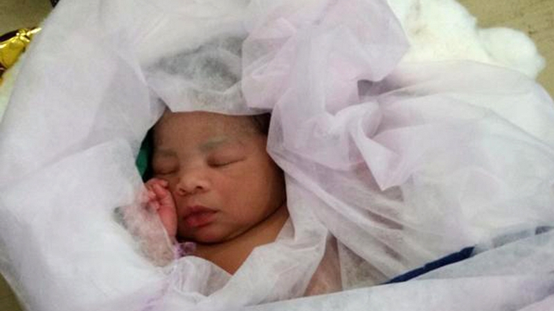 A baby sleeps following its birth aboard an Italian navy rescue boat