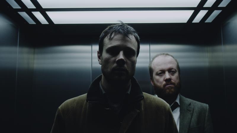 Rupert Evans as the haunted fillm archivist David and Steve Oram as Inspector McNamara in The Canal