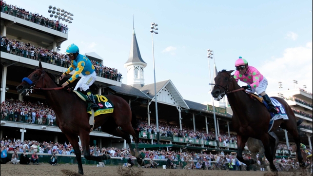Victor Espinoza partners American Pharoah to victory in the 141st running of the Kentucky Derby at Churchill Downs in front of a record crowd of 170,513