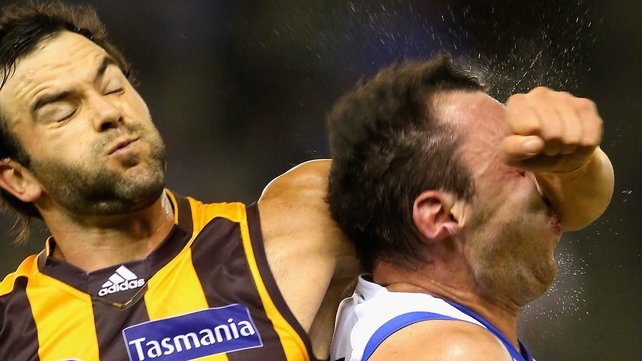 Kangaroos' Todd Goldstein feels the force of the forearm of Jordan Lewis of the Hawks during the AFL match between the North Melbourne Kangaroos and the Hawthorn Hawks at Etihad Stadium in Melbourne