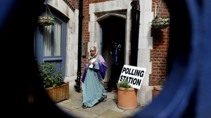 People leave after casting their votes at a polling station in Brick Lane, east London
