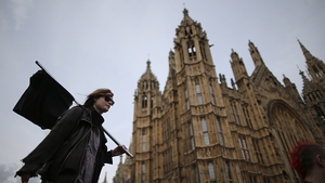 A demonstrator carries a black flag during a protest at Parliament Square in London