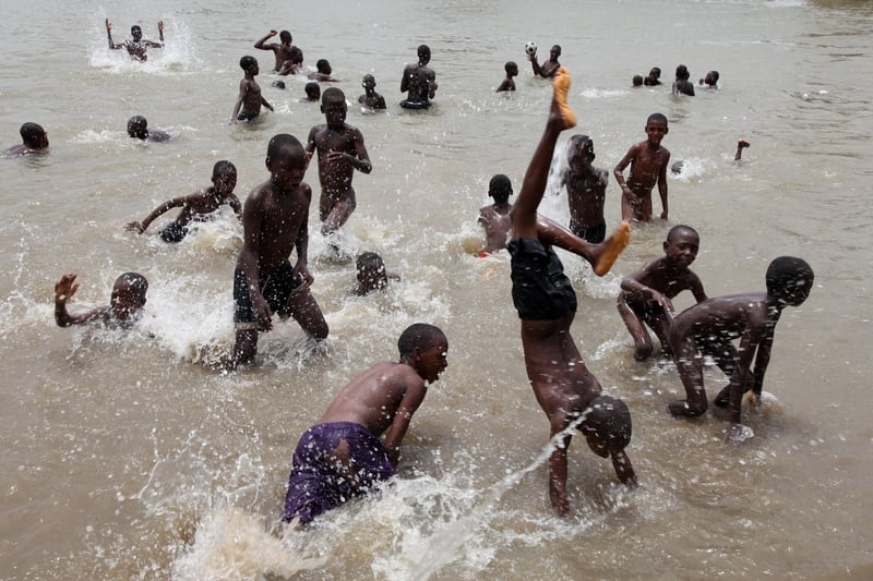 Children enjoy games in the waters of the Benue river, Nigeria