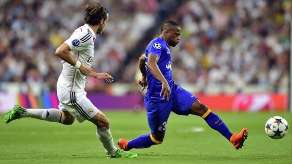 Patrice Evra (R) in action against Real Madrid's Gareth Bale
