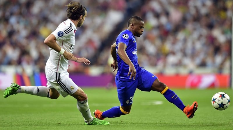 Patrice Evra (R) in action against Real Madrid's Gareth Bale