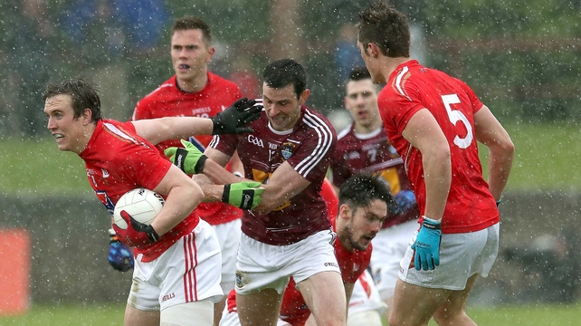 Louth's Bevan Duffy and John Stapleton of Westmeath battle for possession as the rain falls