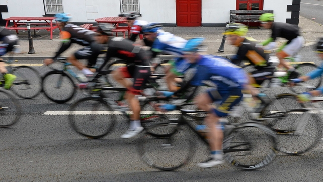 The peloton makes its way past The Chaser pub in Pallasgreen, Co Limerick