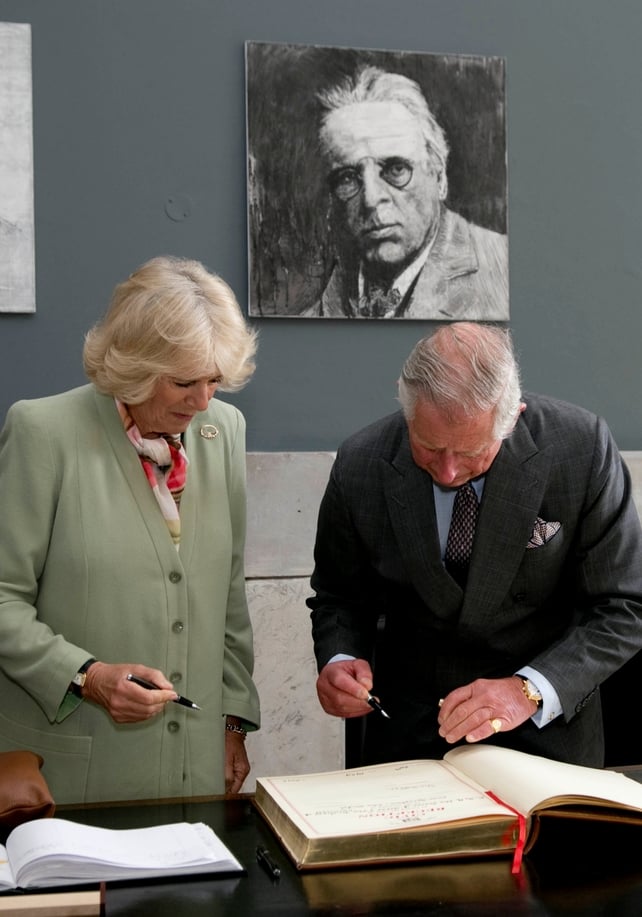 Prince Charles and Camilla sign the visitors' book