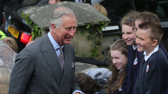 Prince Charles meets some local children before entering the Model Arts Centre
