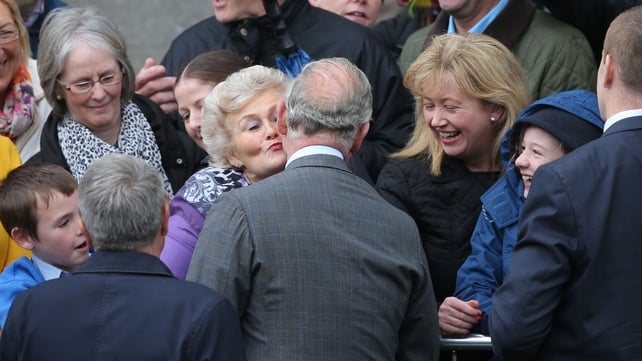 The Prince of Wales gives Marie Conlon a kiss on her 72nd birthday