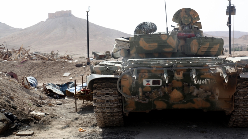 A Syrian armoured tank takes up position during fighting against IS in Palmyra earlier this week
