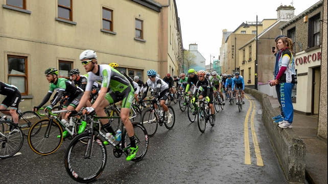 Two young spectators survey the peleton as it leaves Newport