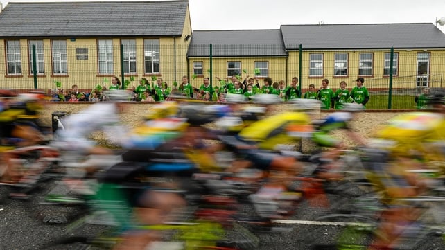 Children from St. Lassara's National School, Ballinacarrow, Co. Sligo, cheer as the peloton passes